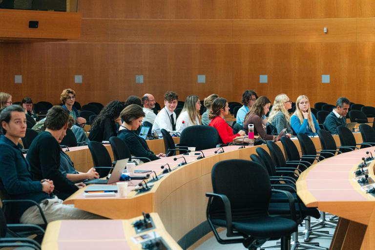 A group of people sitting at tables in a room.