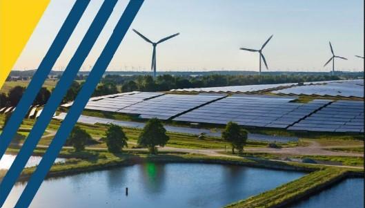 An image of wind turbines and a pond.