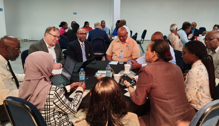 Professionals engaged in a collaborative discussion at a roundtable meeting.