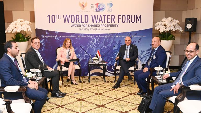 Delegates seated and discussing at the 10th World Water Forum in Bali, Indonesia, with a backdrop reading "Water for Shared Prosperity," set for May 18-25, 2024.