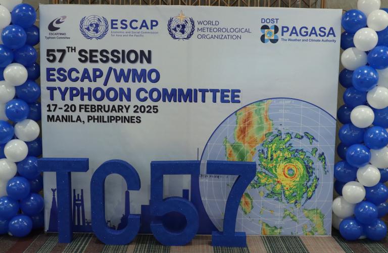 Backdrop for the 57th ESCAP/WMO Typhoon Committee session with logos, dates, location, and decorative balloons.